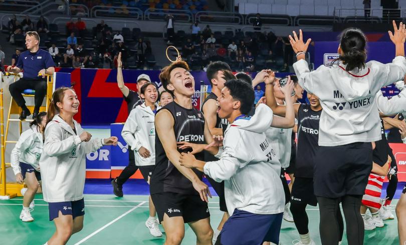 Юниоры Малайзии в чёрной форме Yonex ликуют на корте после победы над Индонезией в полуфинале Кубка Сухандинаты в Каире: крик, объятия, поднятая ракетка (фото: BWF/Badmintonphoto — Raphael Sachetat)